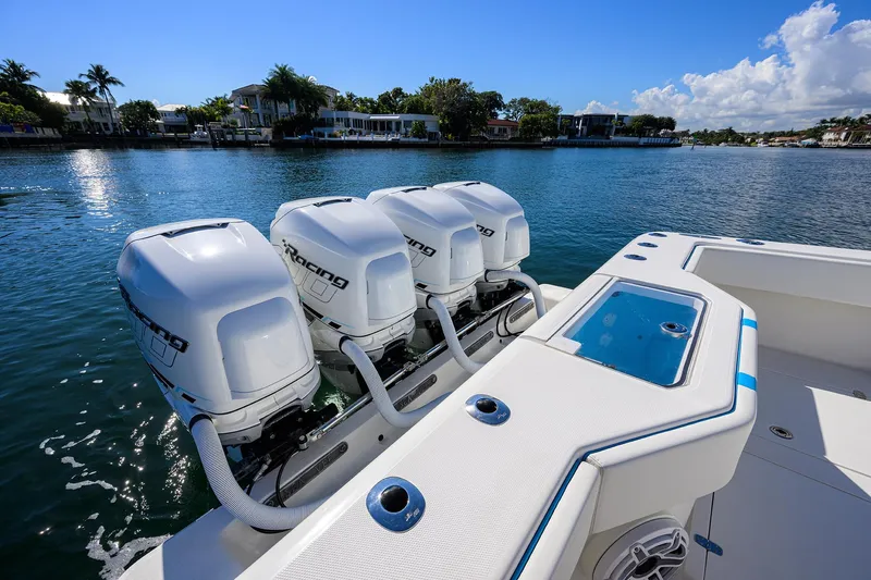  Yacht Photos Pics 2008 SeaVee 39b boat with four powerful outboard engines on a sunny waterfront.