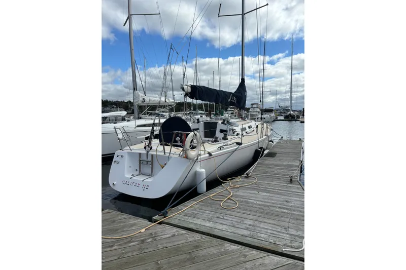 Jane Yacht Photos Pics 2002 J Boats J/120 sailboat docked at marina under cloudy sky.