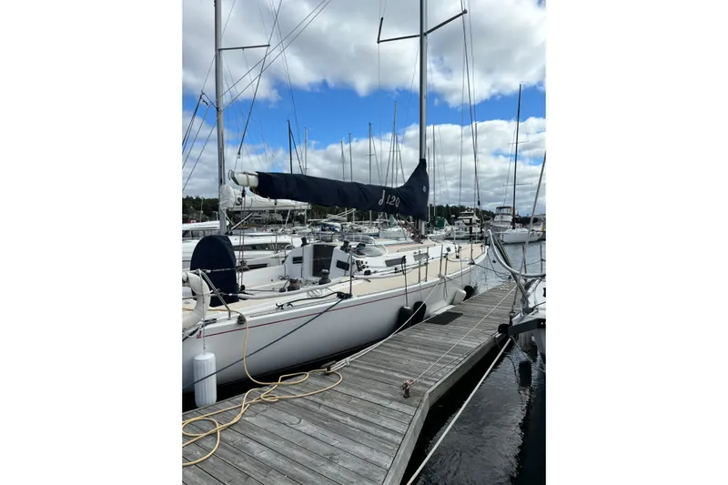Jane Yacht Photos Pics 2002 J Boats J/120 sailboat docked at marina under cloudy sky.