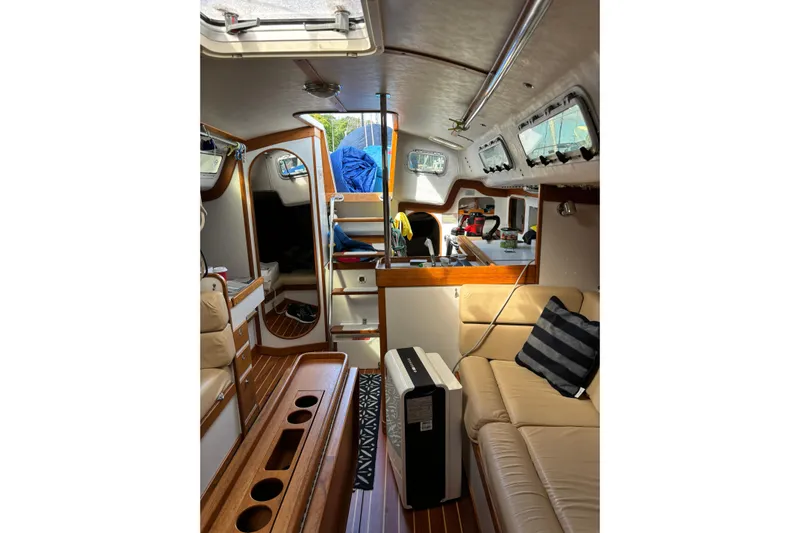 Jane Yacht Photos Pics Interior of 2002 J Boats J/120 sailboat with cozy seating and wooden accents.