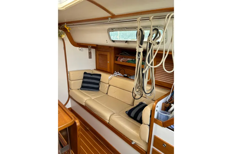 Jane Yacht Photos Pics Interior of 2002 J Boats J/120 sailboat with beige seating and nautical decor.