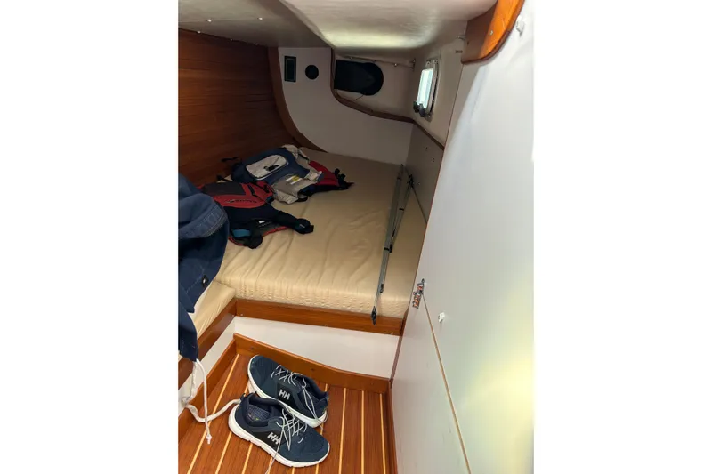 Jane Yacht Photos Pics Cozy cabin interior of 2002 J Boats J/120 with bed and shoes.
