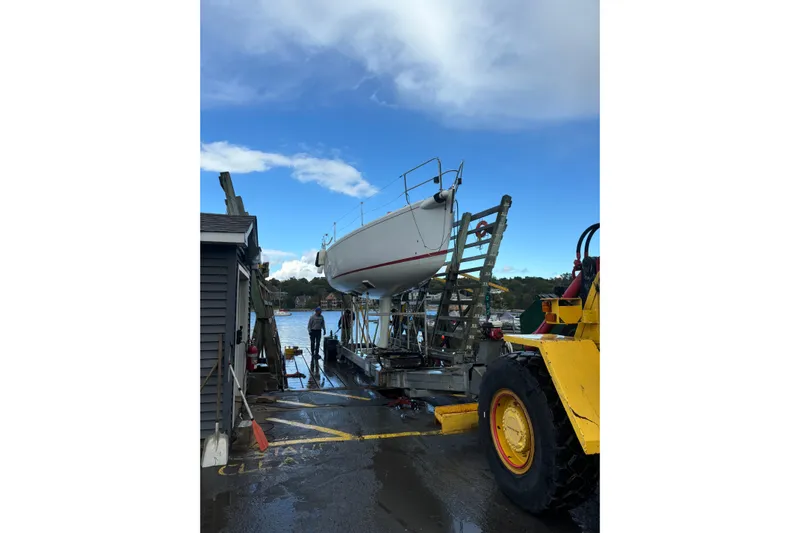 Jane Yacht Photos Pics 2002 J Boats J/120 sailboat on trailer by waterfront, clear sky.