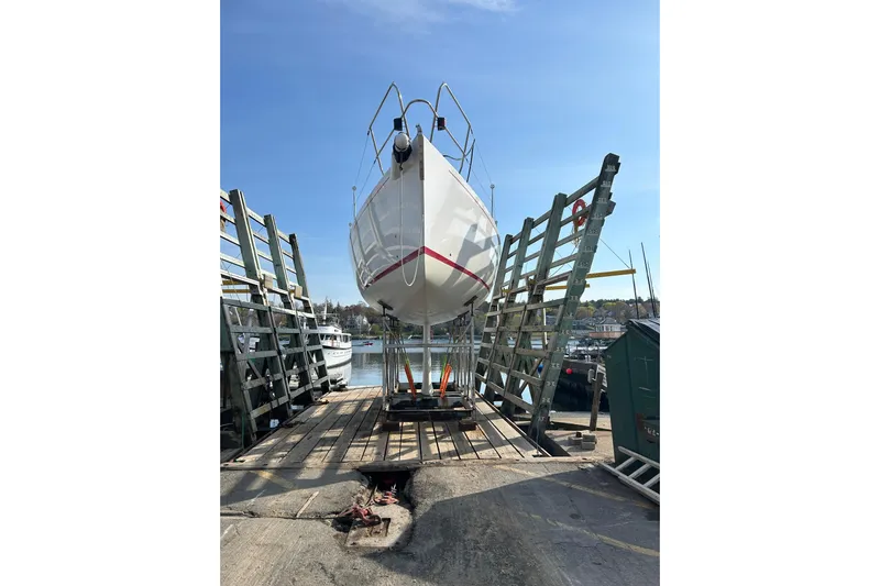Jane Yacht Photos Pics 2002 J Boats J/120 sailboat on dry dock, clear sky background.