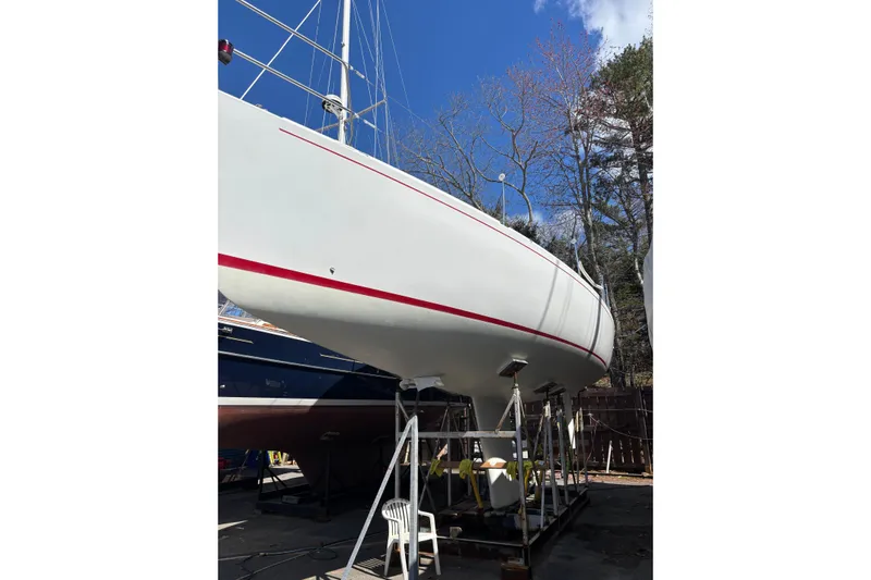 Jane Yacht Photos Pics 2002 J Boats J/120 sailboat on stands, clear sky background.
