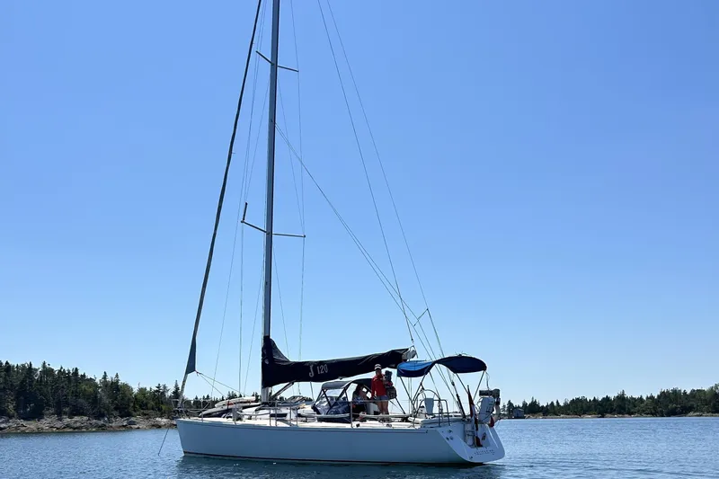 Jane Yacht Photos Pics 2002 J Boats J/120 sailboat on calm water under clear blue sky.