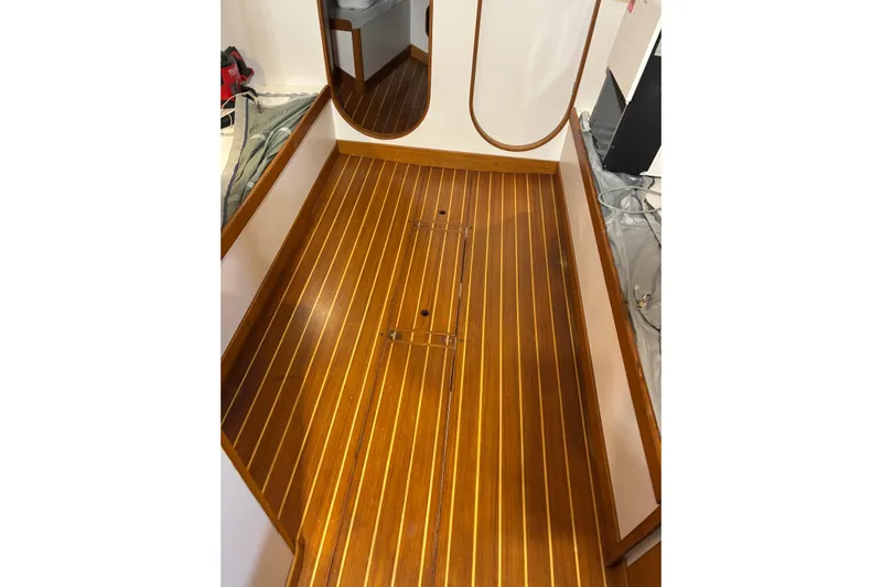 Jane Yacht Photos Pics Teak interior flooring of 2002 J Boats J/120 sailboat, showcasing elegant craftsmanship.