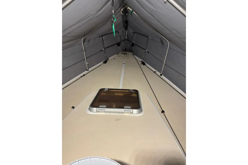 Jane Yacht Photos Pics 2002 J Boats J/120 deck under cover, featuring a central hatch.