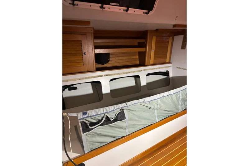 Jane Yacht Photos Pics Interior of 2002 J Boats J/120 sailboat with wooden cabinets and storage compartments.