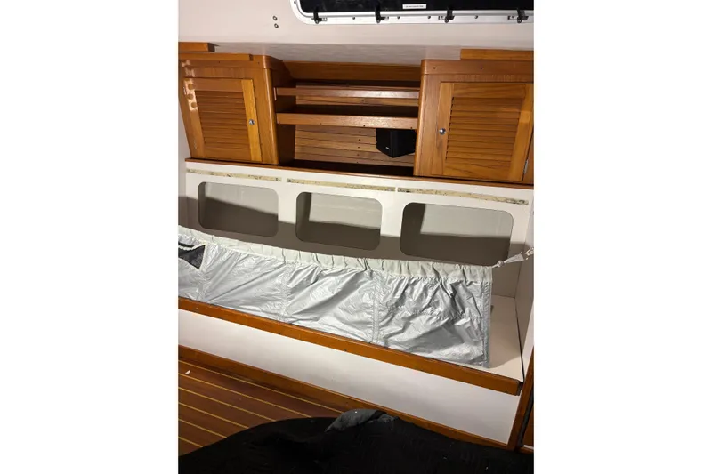 Jane Yacht Photos Pics Interior of 2002 J Boats J/120 sailboat with wooden cabinets and storage area.