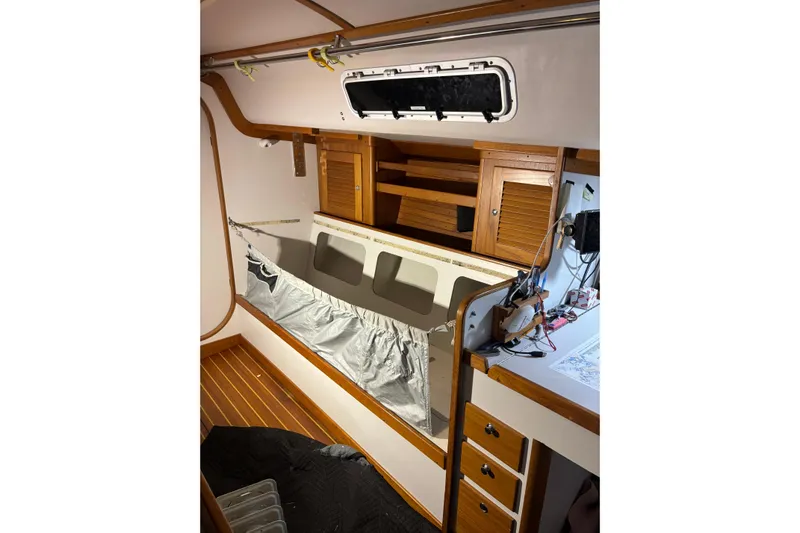 Jane Yacht Photos Pics Interior of 2002 J Boats J/120 sailboat with wooden cabinetry and storage space.