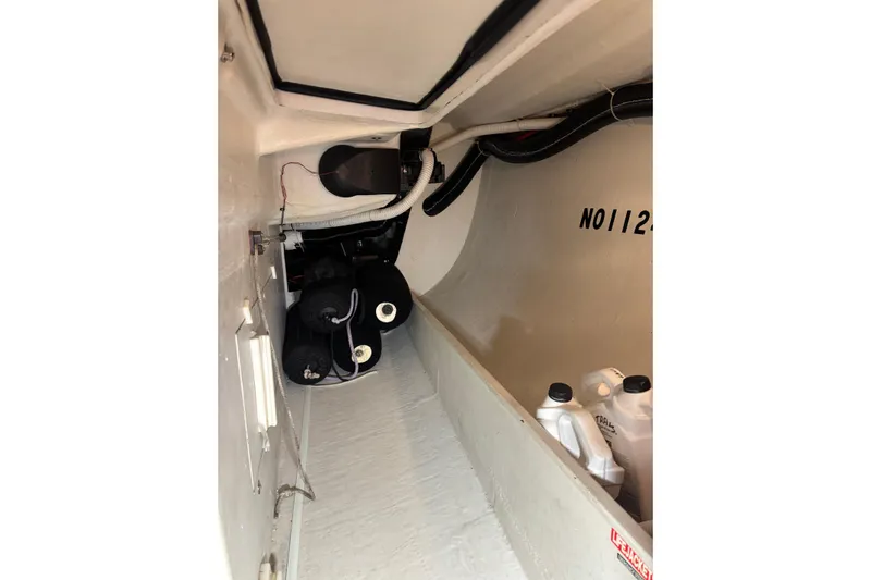 Jane Yacht Photos Pics Interior view of 2002 J Boats J/120 sailboat storage compartment with equipment and supplies.