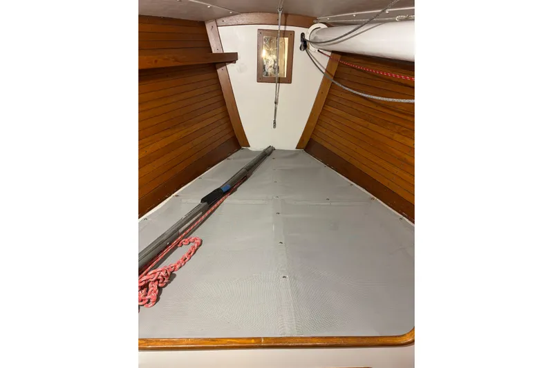 Jane Yacht Photos Pics Interior of 2002 J Boats J/120 sailboat with wooden paneling and ropes.