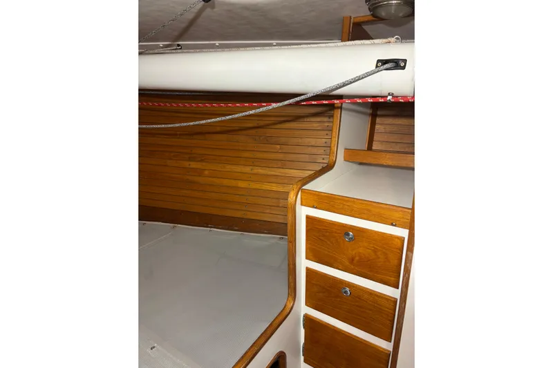 Jane Yacht Photos Pics Interior of 2002 J Boats J/120, featuring wooden cabinetry and sleek design elements.