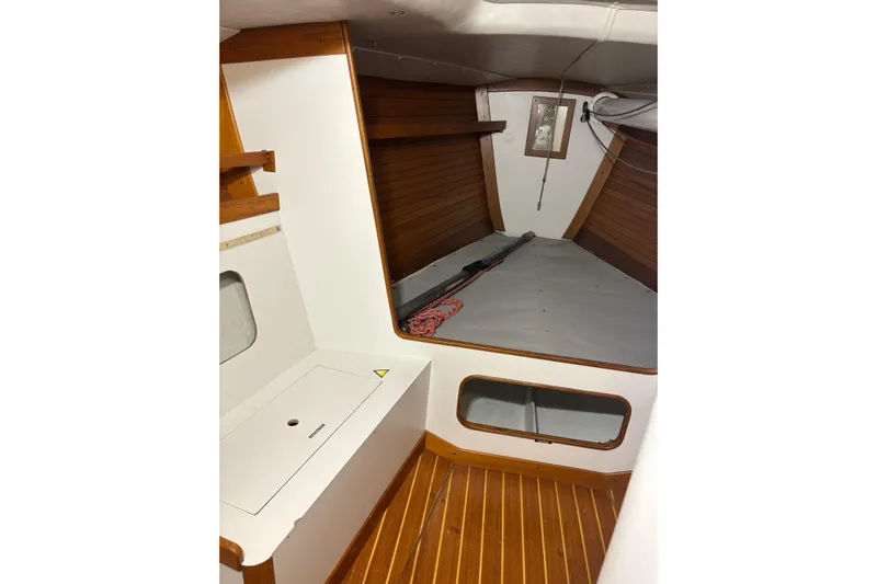 Jane Yacht Photos Pics Interior of 2002 J Boats J/120 sailboat with wooden flooring and storage space.