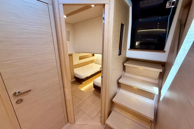 Yacht Photos Pics Interior of 2026 Pardo Yachts 50, featuring wooden stairs and cozy cabin.
