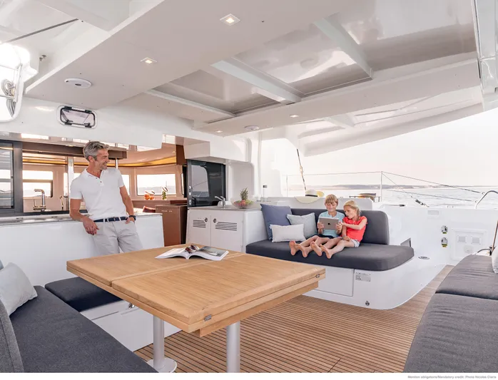 Martina Yacht Photos Pics Family relaxing on Lagoon 46 yacht's spacious deck, 2021 model.