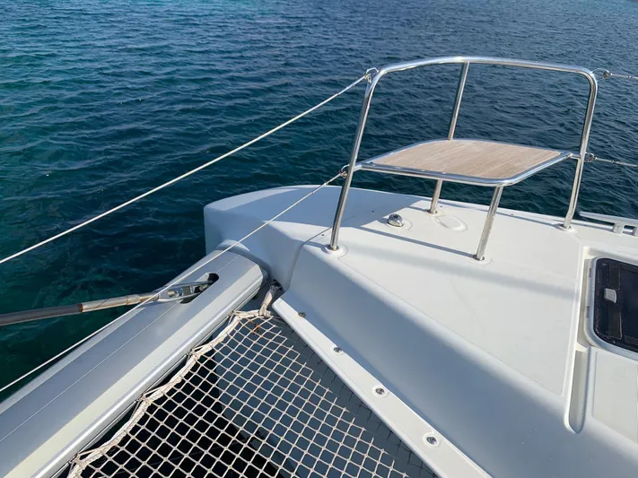 Martina Yacht Photos Pics Lagoon 46 catamaran deck with netting, railing, and ocean view, 2021 model.