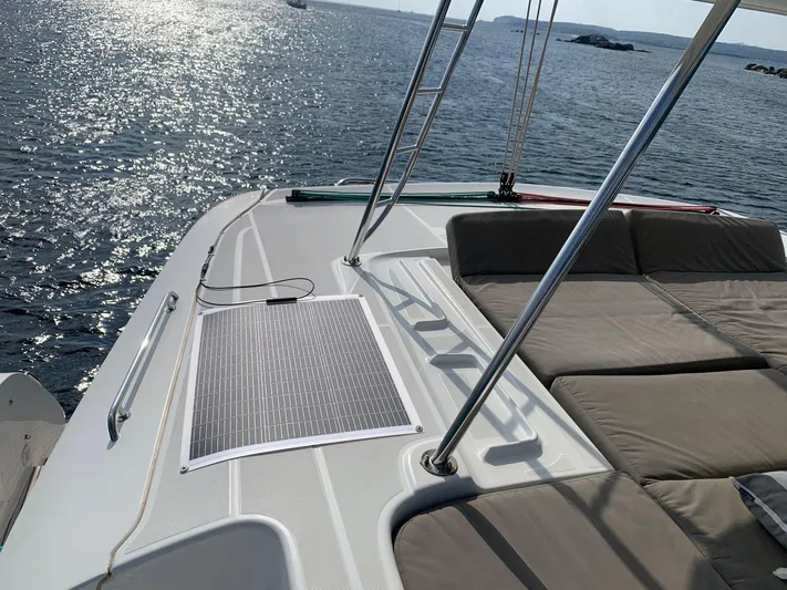 Martina Yacht Photos Pics Luxurious Lagoon 46 catamaran deck with solar panel, 2021 model, overlooking serene ocean waters.