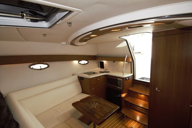 Finn Yacht Photos Pics Interior of 2006 Tiara Yachts 3000 Open, featuring a cozy seating area and kitchenette.