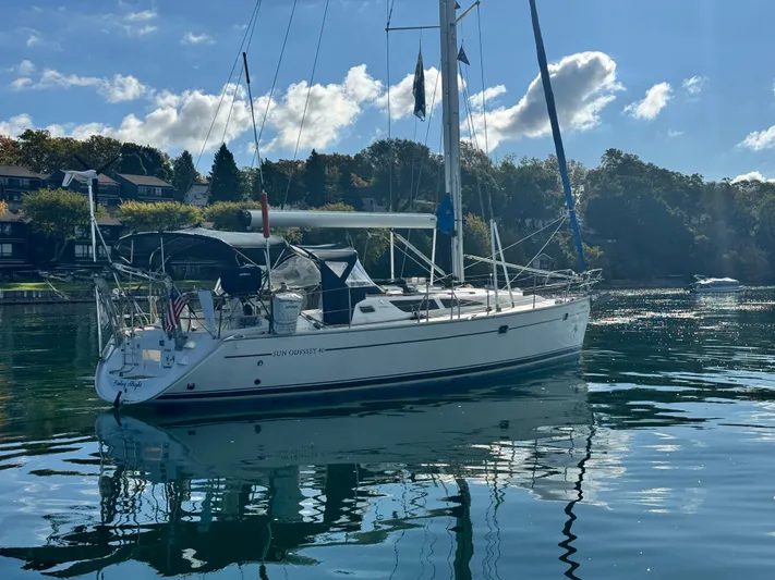 Heeling Alright Yacht Photos Pics 2001 Jeanneau Sun Odyssey 40 sailboat on calm water, with scenic background.