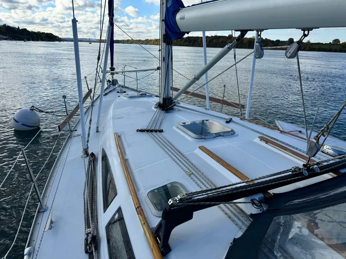 Heeling Alright Yacht Photos Pics Sailing yacht Jeanneau Sun Odyssey 40, 2001 model, on calm waters under a partly cloudy sky.