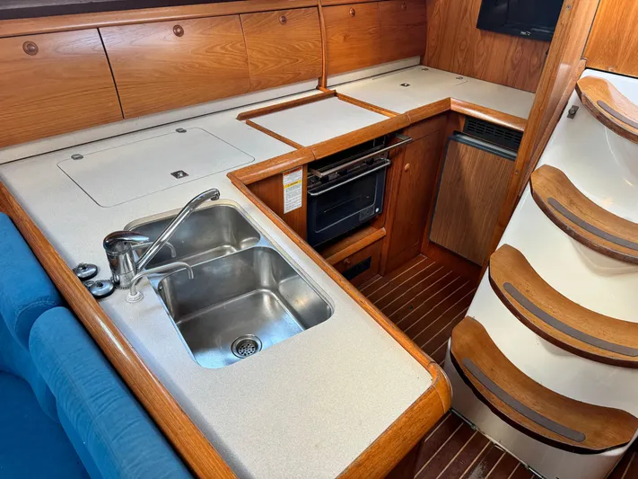 Heeling Alright Yacht Photos Pics Interior of 2001 Jeanneau Sun Odyssey 40 yacht kitchen with sink and oven.