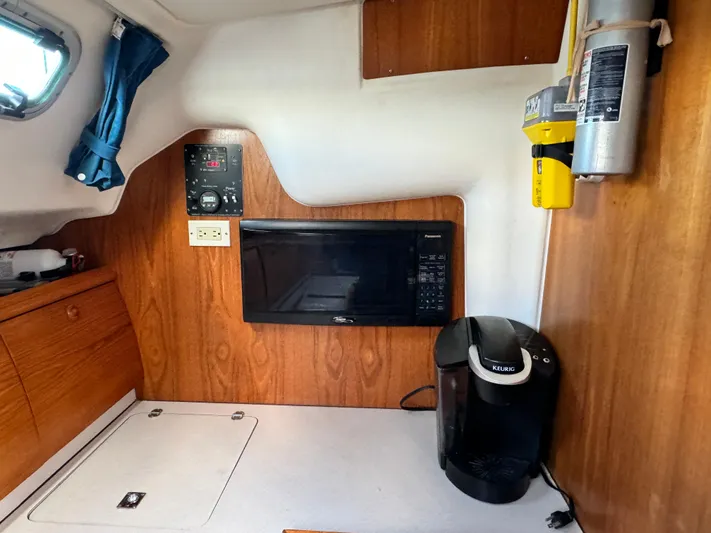 Heeling Alright Yacht Photos Pics Interior of 2001 Jeanneau Sun Odyssey 40 with microwave and coffee maker.