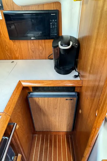 Heeling Alright Yacht Photos Pics Galley of 2001 Jeanneau Sun Odyssey 40 with microwave, coffee maker, and compact fridge.