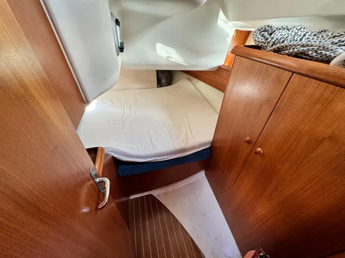 Heeling Alright Yacht Photos Pics Cabin interior of 2001 Jeanneau Sun Odyssey 40 sailboat with wooden furnishings.