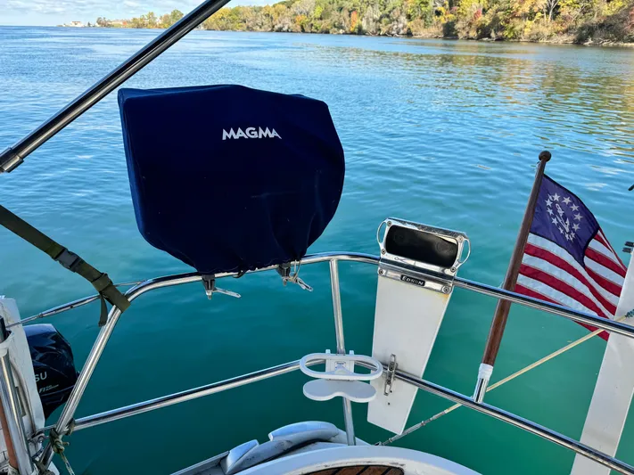 Heeling Alright Yacht Photos Pics Jeanneau Sun Odyssey 40 sailboat, 2001 model, with American flag on calm waters.