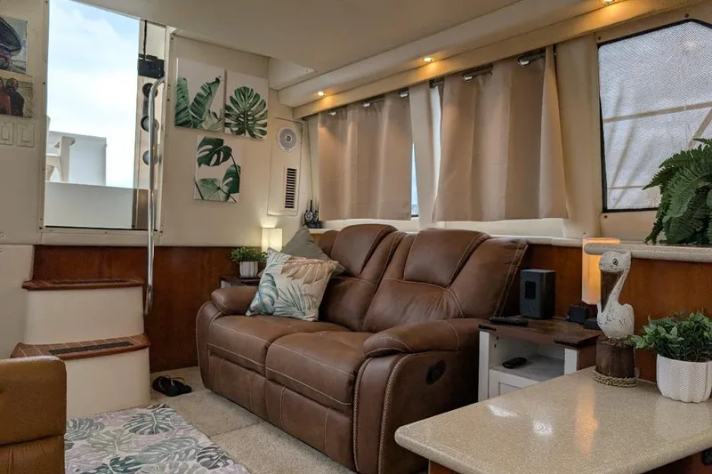 This New Interior Is Amazing! Yacht Photos Pics Interior of 2003 Carver 356 Motor Yacht with cozy seating and tropical decor.