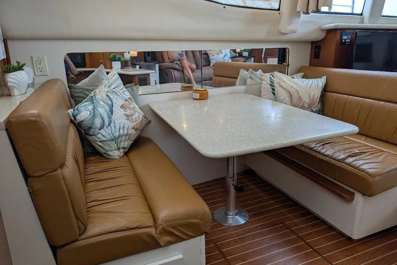 This New Interior Is Amazing! Yacht Photos Pics Interior of 2003 Carver 356 Motor Yacht with leather seating and dining table.