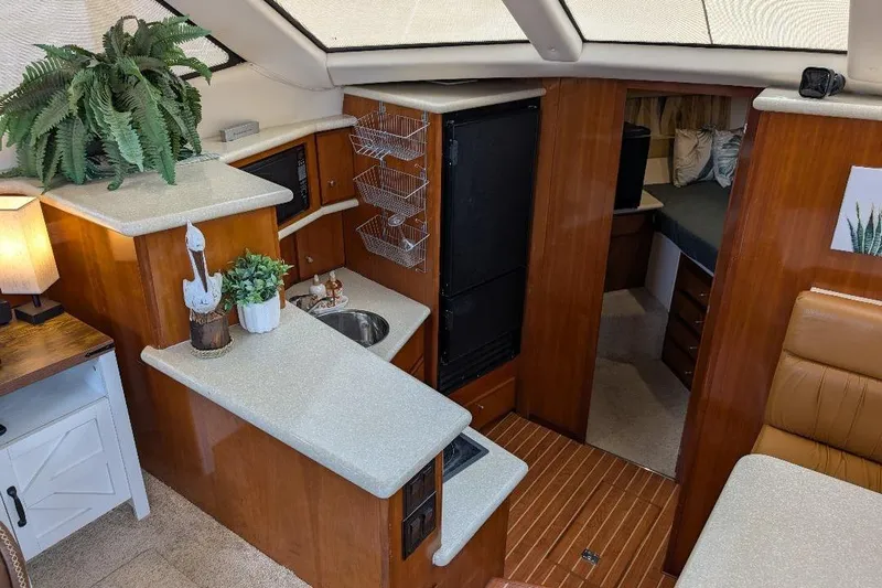 This New Interior Is Amazing! Yacht Photos Pics Interior of 2003 Carver 356 Motor Yacht with kitchenette and cozy seating area.