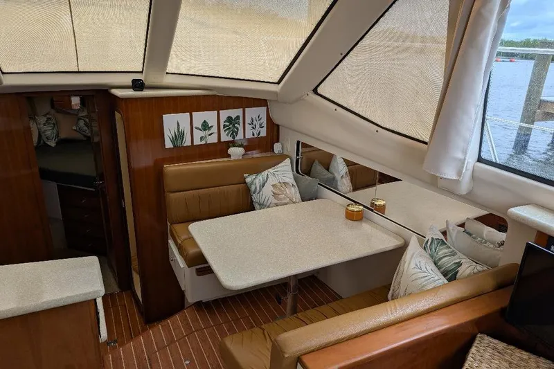 This New Interior Is Amazing! Yacht Photos Pics Interior of 2003 Carver 356 Motor Yacht with dining area and decorative pillows.
