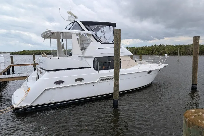 This New Interior Is Amazing! Yacht Photos Pics 2003 Carver 356 Motor Yacht docked on a cloudy day.