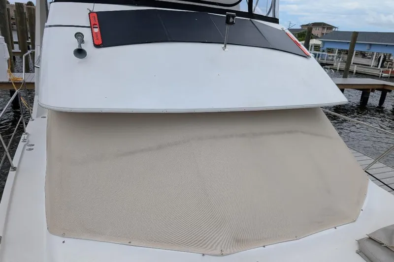 This New Interior Is Amazing! Yacht Photos Pics 2003 Carver 356 Motor Yacht with covered deck, docked at marina.