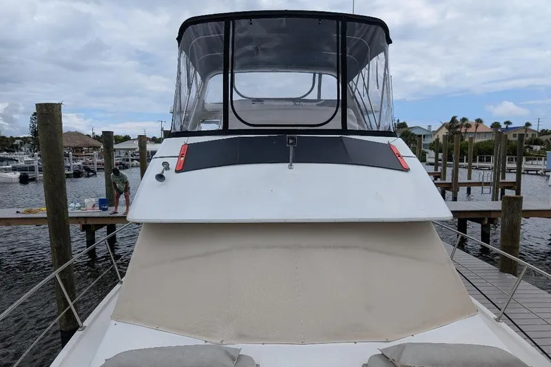 This New Interior Is Amazing! Yacht Photos Pics 2003 Carver 356 Motor Yacht docked at marina, featuring spacious upper deck and sleek design.