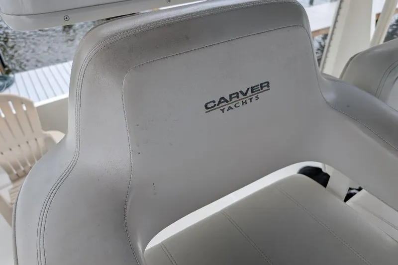 This New Interior Is Amazing! Yacht Photos Pics Carver 356 Motor Yacht 2003 captain's chair with logo, white upholstery.