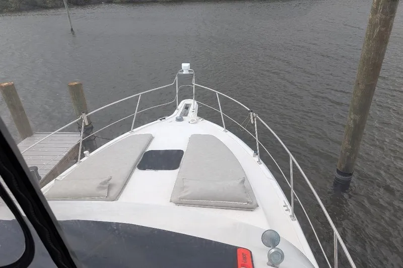 This New Interior Is Amazing! Yacht Photos Pics Bow view of 2003 Carver 356 Motor Yacht docked by wooden posts.