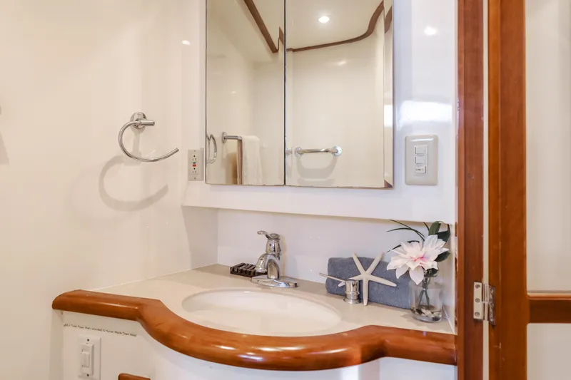 Tribeless Yacht Photos Pics Luxurious bathroom in 2002 Mikelson 70 Sportfisher yacht with elegant fixtures and decor.