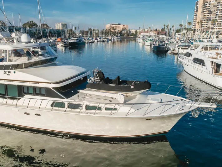 Tribeless Yacht Photos Pics Mikelson 70 Sportfisher 2002 yacht docked in a marina with other boats.