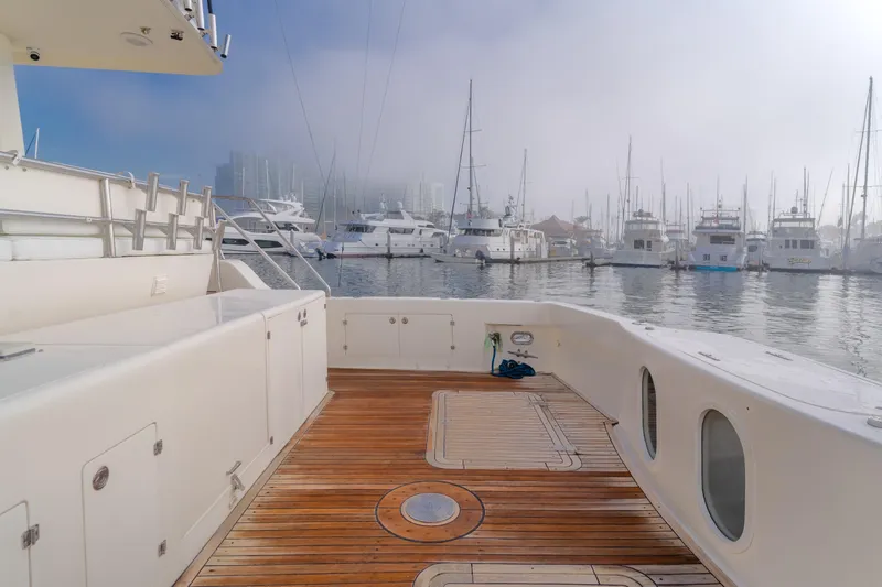 Tribeless Yacht Photos Pics Mikelson 70 Sportfisher 2002 yacht deck with marina view in foggy weather.