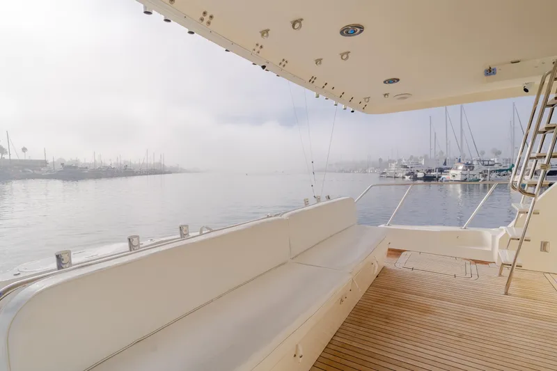Tribeless Yacht Photos Pics Mikelson 70 Sportfisher 2002 yacht deck overlooking marina in foggy weather.