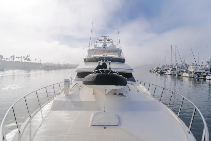 Tribeless Yacht Photos Pics Mikelson 70 Sportfisher 2002 yacht docked in a misty marina.