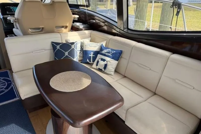 Lady Laura Yacht Photos Pics Luxurious interior of 2016 Sea Ray Sundancer 400 yacht with elegant seating and nautical-themed pillows.