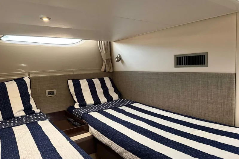 Lady Laura Yacht Photos Pics Cabin interior of 2016 Sea Ray Sundancer 400 with twin beds and striped bedding.