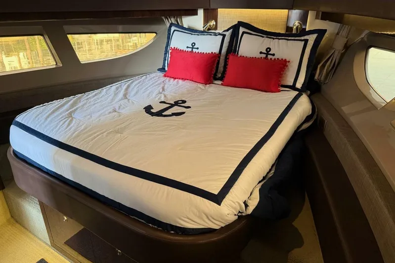 Lady Laura Yacht Photos Pics Luxurious cabin interior of 2016 Sea Ray Sundancer 400 yacht with nautical-themed bedding.
