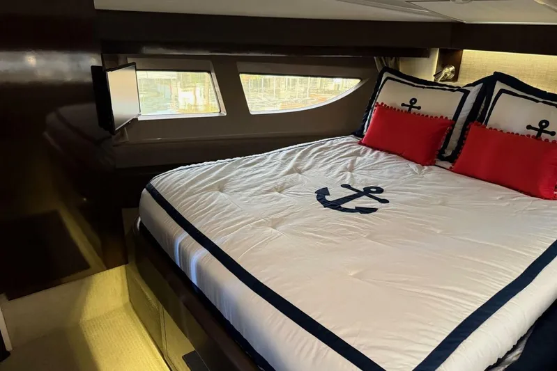 Lady Laura Yacht Photos Pics Luxurious cabin interior of 2016 Sea Ray Sundancer 400 with nautical-themed bedding.