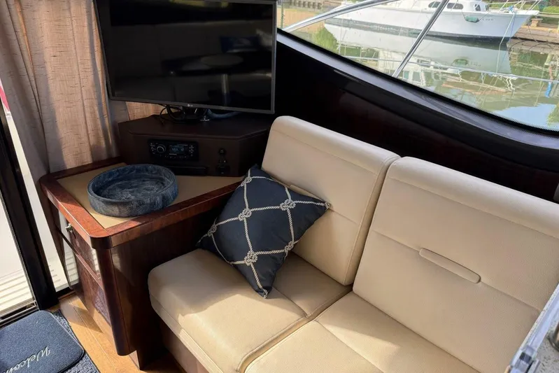 Lady Laura Yacht Photos Pics Interior of 2016 Sea Ray Sundancer 400 yacht with beige seating and a TV.